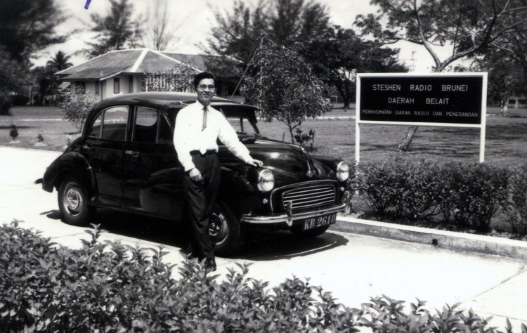 Chong See Kui showing off his first car KB2618 with a photo taken in front of Radio Brunei where he worked since 1960 